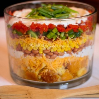 This Cornbread Salad is the perfect easy-to-follow layered salad recipe. Serve in a glass trifle bowl to show off the colorful layers. A simple and delicious recipe!