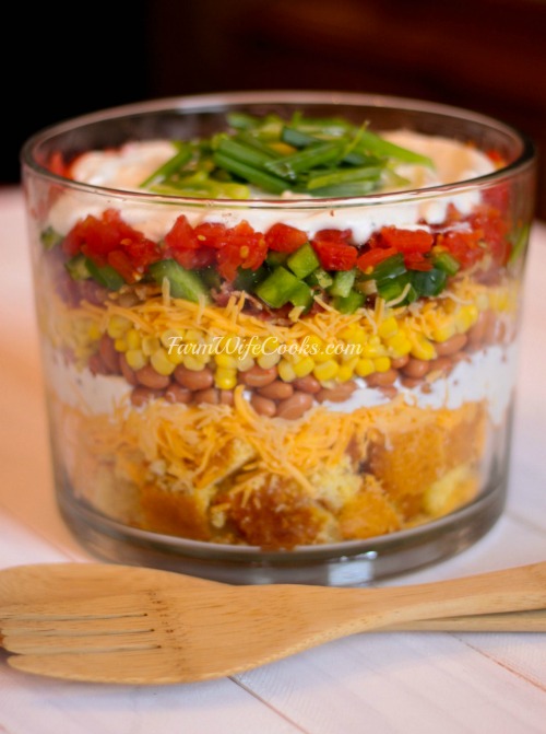 This Cornbread Salad is the perfect easy-to-follow layered salad recipe. Serve in a glass trifle bowl to show off the colorful layers. A simple and delicious recipe! 