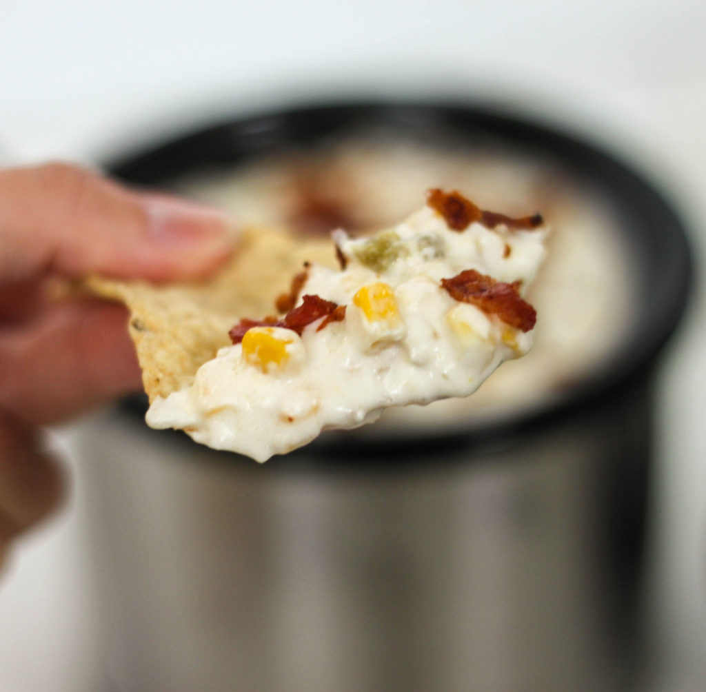 Great crock pot dip recipe with corn and bacon! Perfect for tailgating or to make while watching the big game. 