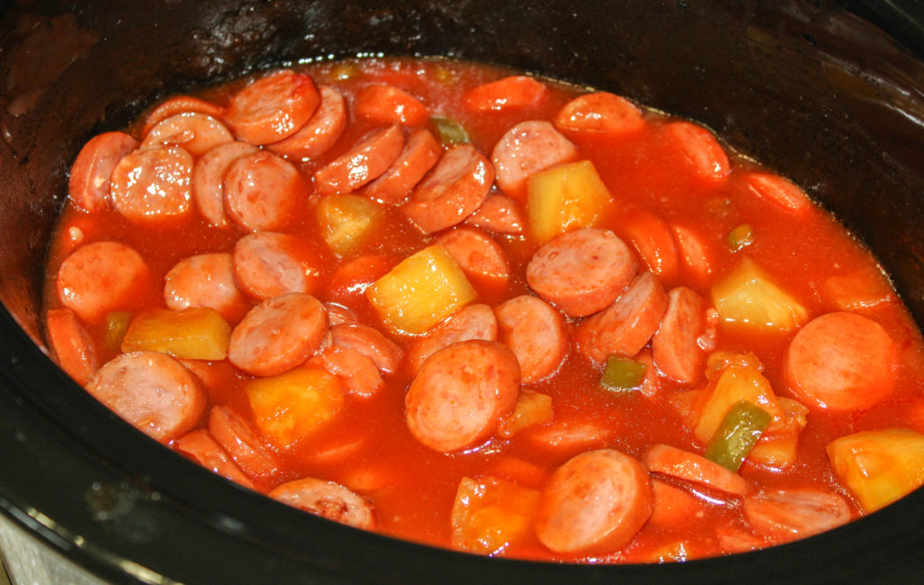 Are you looking for something a little different for the game, dinner or to take to a potluck? This Sweet and Sour Smoked Sausage will be a hit with any crowd! Made in the crock pot!