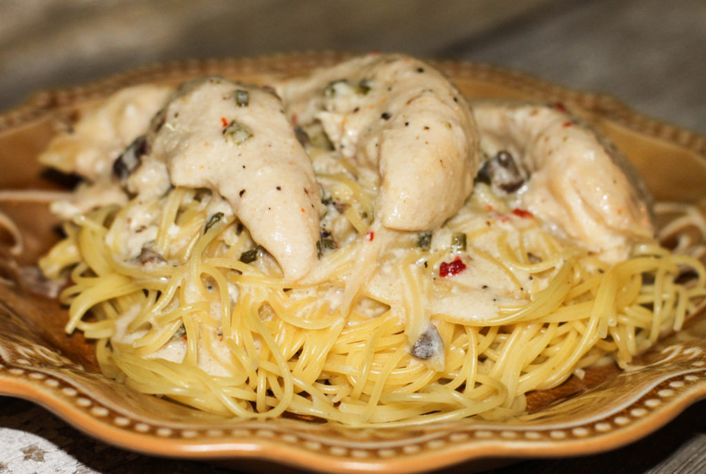 This Angel Chicken is an easy crockpot chicken recipe that the whole family will love! Serve the chicken over pasta. One of my favorite slow cooker recipes!