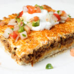 Deep Dish Taco Squares are an easy ground beef casserole recipe that will kick up your families Taco Tuesday.