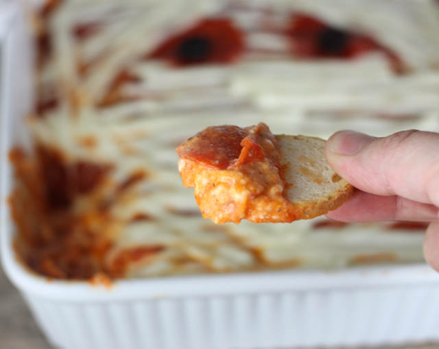 Are you looking for a fun appetizer for Halloween? This Mummy Pizza Dip will be a hit with your ghosts and goblins!
