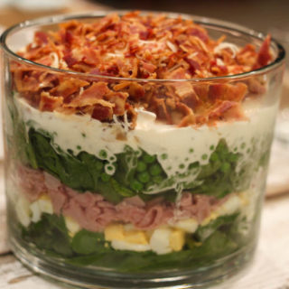Lehua Salad is an easy salad recipe that even the meat and potato lover in your life will love! This salad has layers of spinach, bacon, ham, eggs, cheese and peas.
