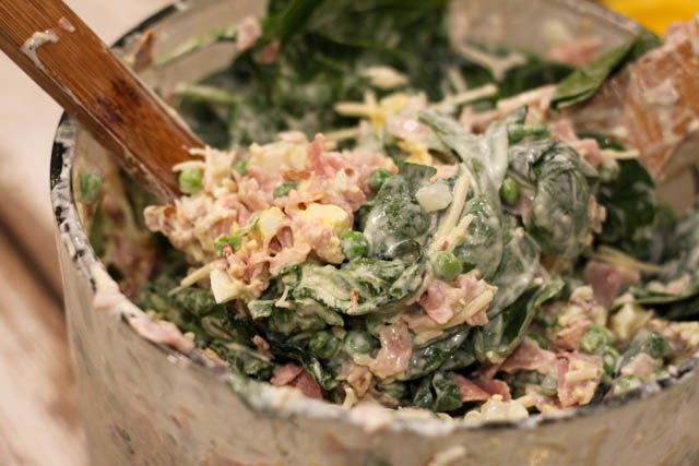 Lehua Salad is an easy salad recipe that even the meat and potato lover in your life will love! This salad has layers of spinach, bacon, ham, eggs, cheese and peas.